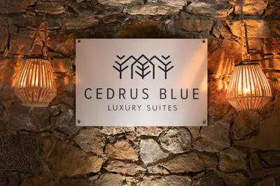 a sign for cedarius blue luxury suites with two lights at Cedrus Blue in Symi