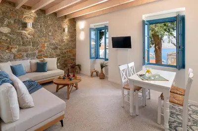 a living room with a couch and a table at Cedrus Blue in Symi