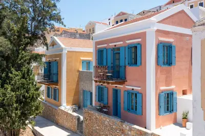 a row of houses with blue shutters at Cedrus Blue in Symi
