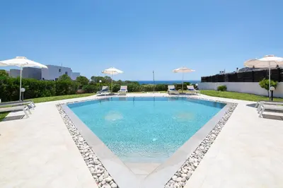 a swimming pool with chairs and umbrellas at Villa Melodia, 4 Bedroom Villa with Private Pool in Líndos