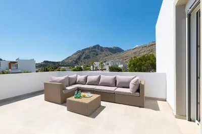 a couch sitting on top of a balcony at Villa Melodia, 4 Bedroom Villa with Private Pool in Líndos