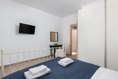 a bedroom with a bed with two towels on it at Villa Melodia, 4 Bedroom Villa with Private Pool in Líndos