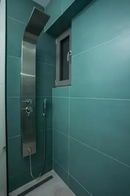 a bathroom with a shower with a blue at Rhodes Diamond luxury flat in the heart of town in Rhodes Town