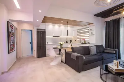 a living room with a couch and a kitchen at Rhodes Diamond luxury flat in the heart of town in Rhodes Town
