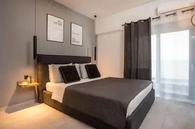 a bedroom with a large bed and a window at Rhodes Diamond luxury flat in the heart of town in Rhodes Town