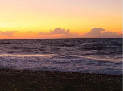 a sunset on the beach with the ocean at Smart Accommodation Rhodes in Rhodes Town
