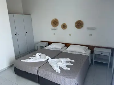 a bedroom with two beds with white towels on them at Smart Accommodation Rhodes in Rhodes Town