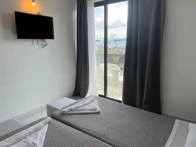 a bedroom with a bed and a window with a view at Smart Accommodation Rhodes in Rhodes Town