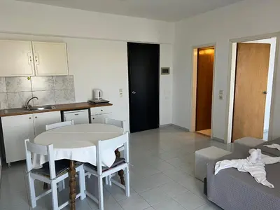 a kitchen and living room with a table and chairs at Smart Accommodation Rhodes in Rhodes Town