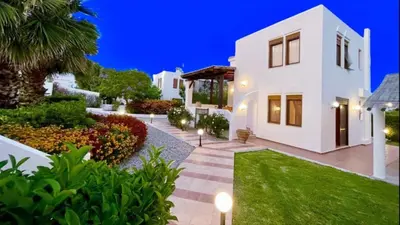 a villa with a garden at night at Tramonto Blue in Gennadi