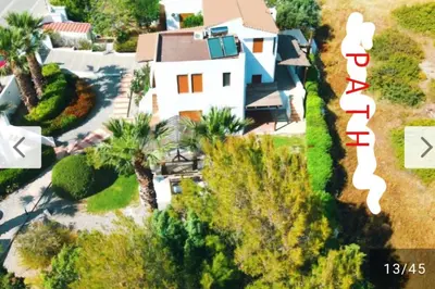 an aerial view of a white house with palm trees at Tramonto Blue in Gennadi