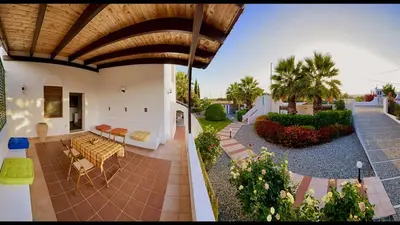 a house with a patio with a table and chairs at Tramonto Blue in Gennadi