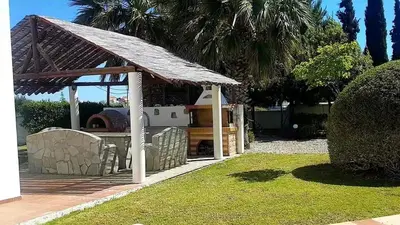 a gazebo with a grill in a yard at Tramonto Blue in Gennadi