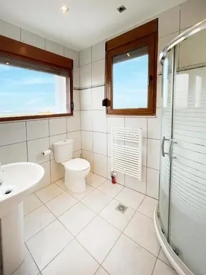 a bathroom with a toilet and a sink and a shower at Tramonto Blue in Gennadi