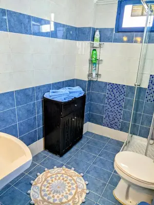 a blue tiled bathroom with a toilet and a tub at House with garden in city of Rhodes in Rhodes Town