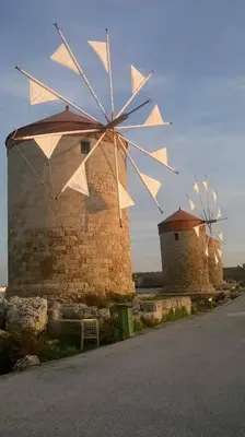 a group of windmills on the side of a building at House with garden in city of Rhodes in Rhodes Town