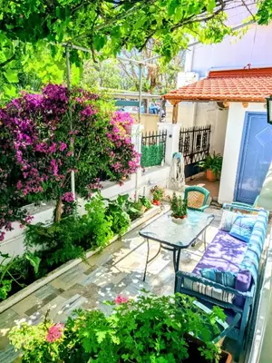 a patio with a table and some flowers at House with garden in city of Rhodes in Rhodes Town