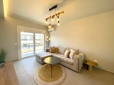 a living room with a couch and a table at Serenity City Apartment in Rhodes Town