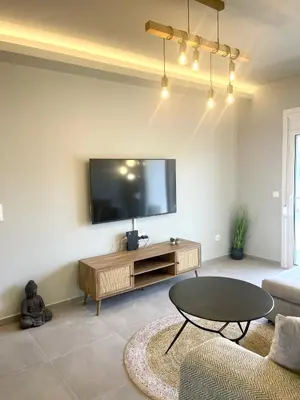 a living room with a tv and a coffee table at Serenity City Apartment in Rhodes Town