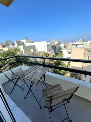 a balcony with two benches and a view of the city at Serenity City Apartment in Rhodes Town