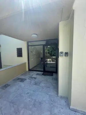 an empty room with glass doors in a building at Serenity City Apartment in Rhodes Town