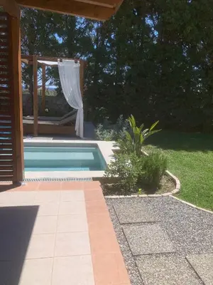 a swimming pool in a yard next to a house at 3 Roses Residence in Afantou