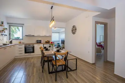 a kitchen and dining room with a table and chairs at My Home in RHO in Koskinou