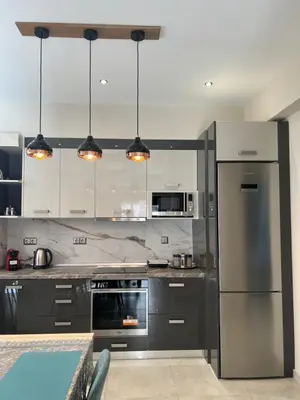 a kitchen with stainless steel appliances and gray cabinets at Psaropoula's Hidden Gem in Rhodes Town