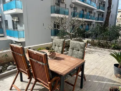 a wooden table and chairs on a patio at Psaropoula's Hidden Gem in Rhodes Town