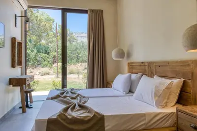 a bedroom with a bed and a large window at Kavos beach house in Pefki Rhodes