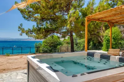 a hot tub with a view of the ocean at Kavos beach house in Pefki Rhodes