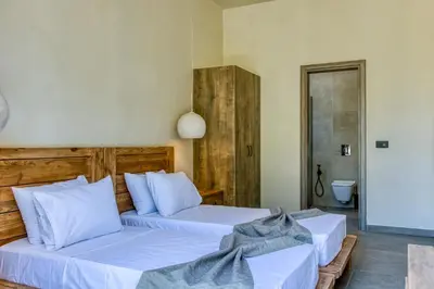 a bedroom with two beds and a bathroom at Kavos beach house in Pefki Rhodes