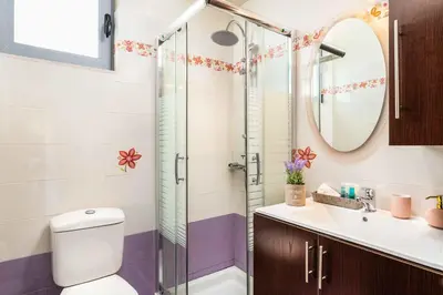 a bathroom with a shower and a toilet and a sink at Villa Ifigeneia in Afantou