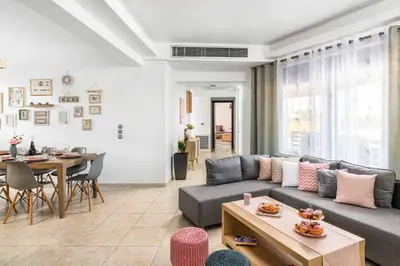 a living room with a couch and a table at Villa Ifigeneia in Afantou