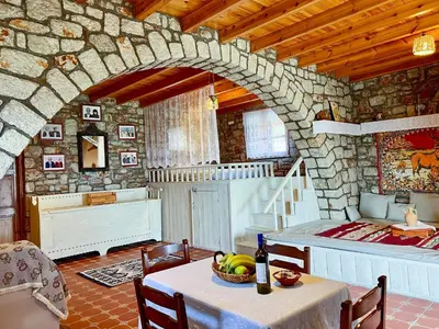 a room with a table with a bowl of fruit on it at Rhodes traditional Cottage with private garden in Archangelos
