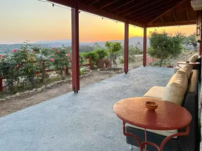 a table and a couch on a patio with a view at Rhodes traditional Cottage with private garden in Archangelos