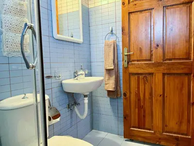 a blue bathroom with a toilet and a sink at Rhodes traditional Cottage with private garden in Archangelos