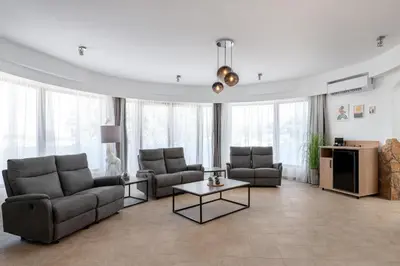a living room with two couches and a table at Hamilton Grand Villa in Koskinou
