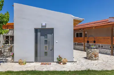 a white house with a gray door on a patio at Casa di Gianna in Rhodes Town