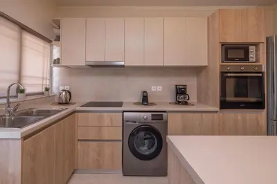 a kitchen with a washing machine and a sink at Casa di Gianna in Rhodes Town