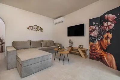 a living room with a couch and a flat screen tv at Casa di Gianna in Rhodes Town