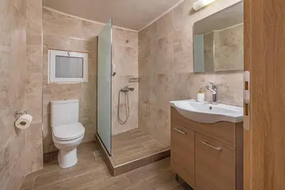a bathroom with a toilet and a shower and a sink at Casa di Gianna in Rhodes Town