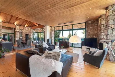 a living room with a couch and a tv at AGROLUX OASIS - A Private Pool Escape in Lush Agricultural Serenity in Sálakos