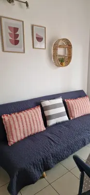 a blue couch with pillows on it in a room at Cosy little studio for family vacations ! in Rhodes Town