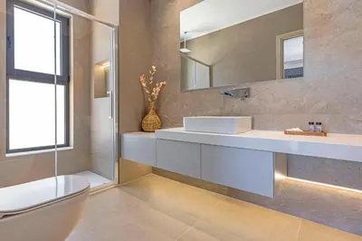a bathroom with a sink and a mirror and a toilet at Mont Fleury Resort in Koskinou