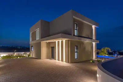 a large house at night with the lights on at Mont Fleury Resort in Koskinou