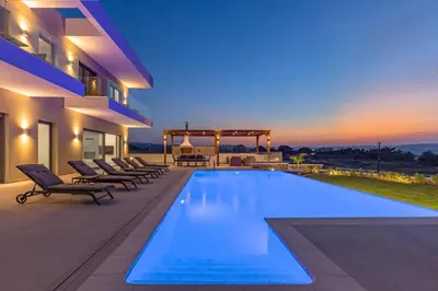a swimming pool on the side of a house at Mont Fleury Resort in Koskinou