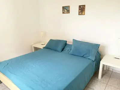 a blue bed with blue pillows in a bedroom at Villa Frangipani with large private pool, Rhodes in Lardos