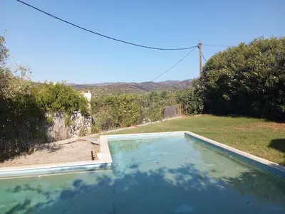 a swimming pool in the backyard of a house at Villa Frangipani with large private pool, Rhodes in Lardos