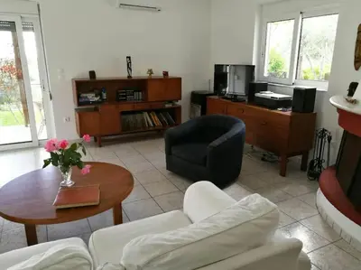 a living room with a couch and a table at Villa Frangipani with large private pool, Rhodes in Lardos